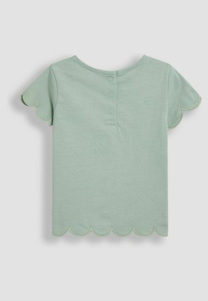 T-shirt en coton vert menthe avec des manches courtes à volants, dotée d'une fermeture à boutons au dos et d'une texture lisse.