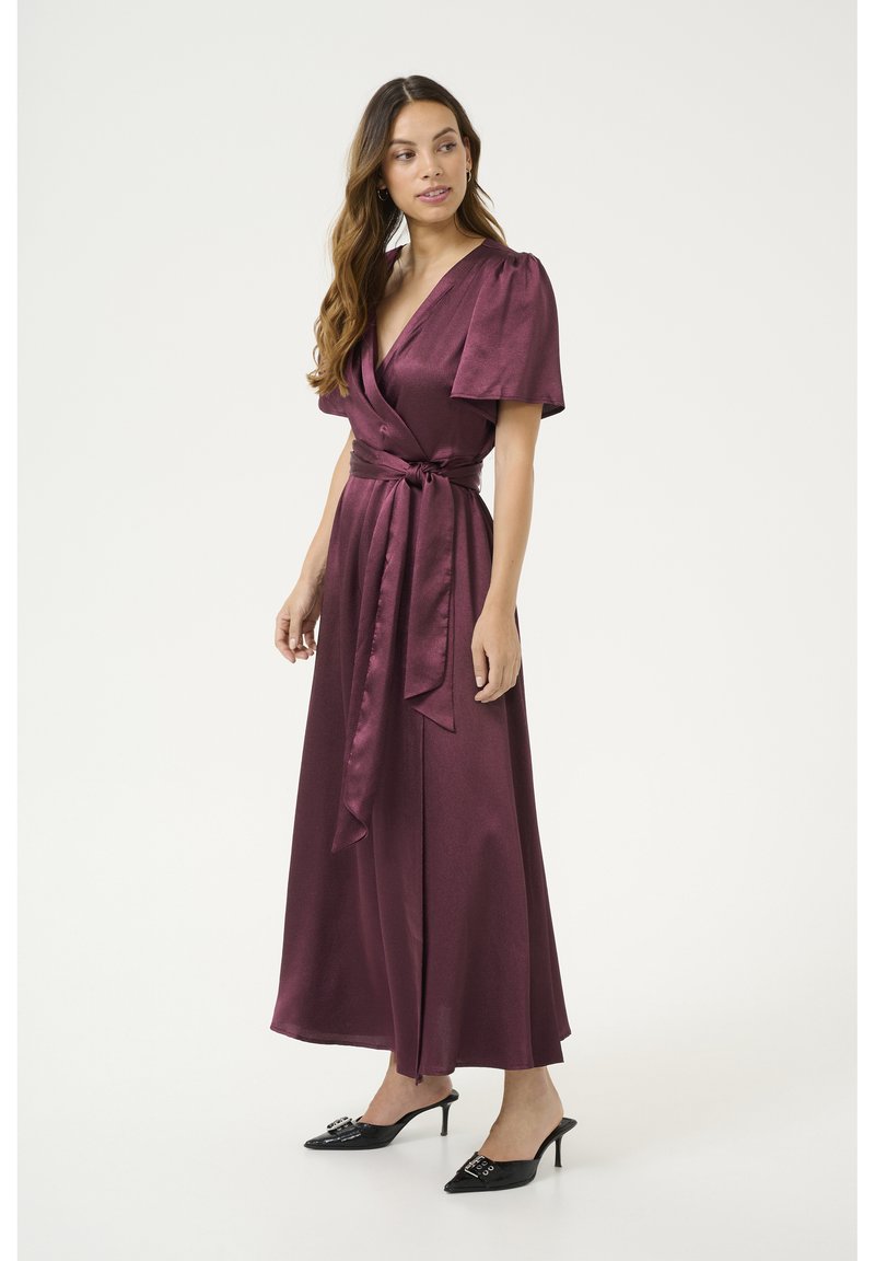 Maroon satin wrap dress with short puff sleeves, a tie belt at the waist, and a floor-length skirt. Glossy texture and smooth drape.
