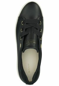 Black leather sneaker with gold hardware accents, featuring lace-up design, padded collar, and white rubber sole. Interior is light-colored.