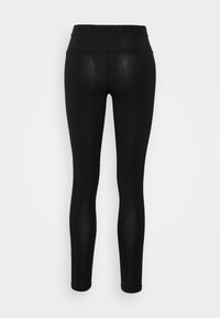 Leggings neri con un alto punto vita caratterizzati da una finitura testurizzata sottile. Il punto vita presenta il nome del marchio ripetuto in lettere nere.