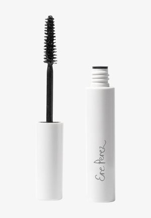 Brosse de mascara noire avec de petites soies à côté d'un contenant cylindrique blanc arborant une étiquette en écriture simple.