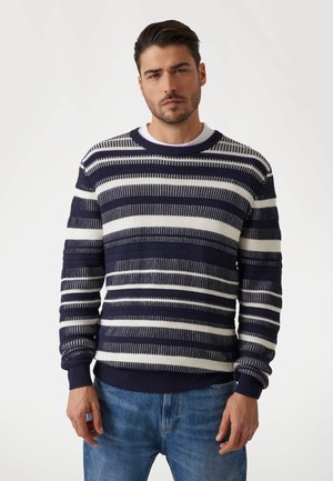 Navy and white striped knit sweater featuring a ribbed crew neckline and textured fabric. Long sleeves with ribbed cuffs and waistband.