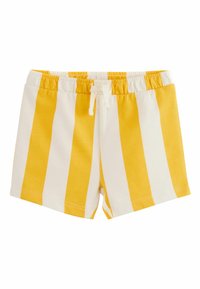 Pantalones cortos con cintura elástica de rayas verticales amarillas y blancas, con un cordón blanco sobre un fondo blanco.