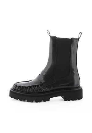 Black leather ankle boot with chunky tread sole, elastic side panels, and gathered detail around the front seam.