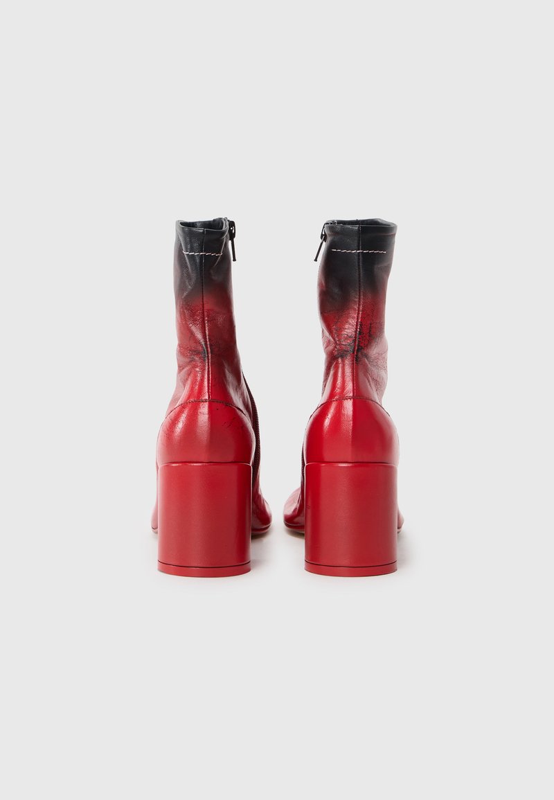 Red leather ankle boots with a gradient black to red finish, rounded toe, and high block heel. Features a zipper at the back.