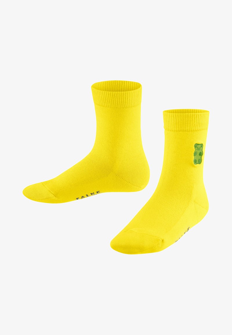 Gelbe Baumwollsocken mit gerippten Bündchen, auf der Seite mit einer grünen Bärengrafik und einem bedruckten Logo an der Unterseite. Mittellange Ausführung bis zur Wade.