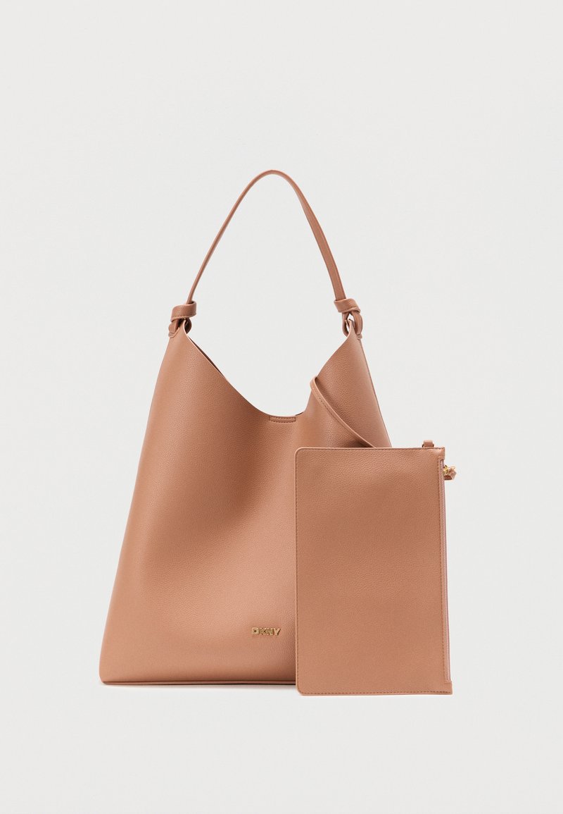 Sac fourre-tout en similicuir marron avec une forme incurvée, une bandoulière unique et une pochette zippée amovible. Marquage doré sur le devant.