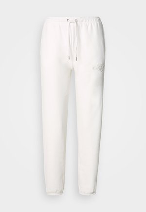 Pantaloni della tuta bianchi realizzati in morbido tessuto, con vita regolabile tramite cordoncino e logo ricamato sulla coscia sinistra. Design con gamba affusolata.