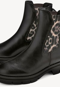 Svarta läderstövletter med glansig yta, med leopardmönstrade elastiska sidopaneler och texturerade gummisulor för bra grepp.