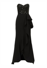 Czarna wieczorowa suknia z bezramiennym, cekinowym gorsetem, zwiewnym materiałem i falbaną po jednej stronie. Długa, dopasowana sylwetka.