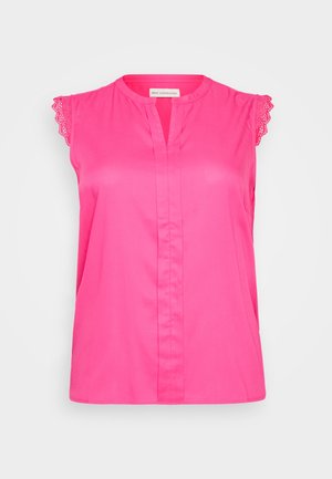 Roza brezrokavnik s čipkastim obrobljanjem na ramenih, z sprednjim zapenjanjem in sproščenim krojem. Gladek material, enotna barva, brez vzorcev.