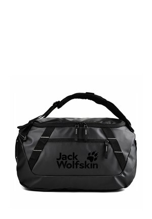 Sac de sport noir Jack Wolfskin avec deux compartiments zippés et bandoulière rembourrée sur fond blanc.