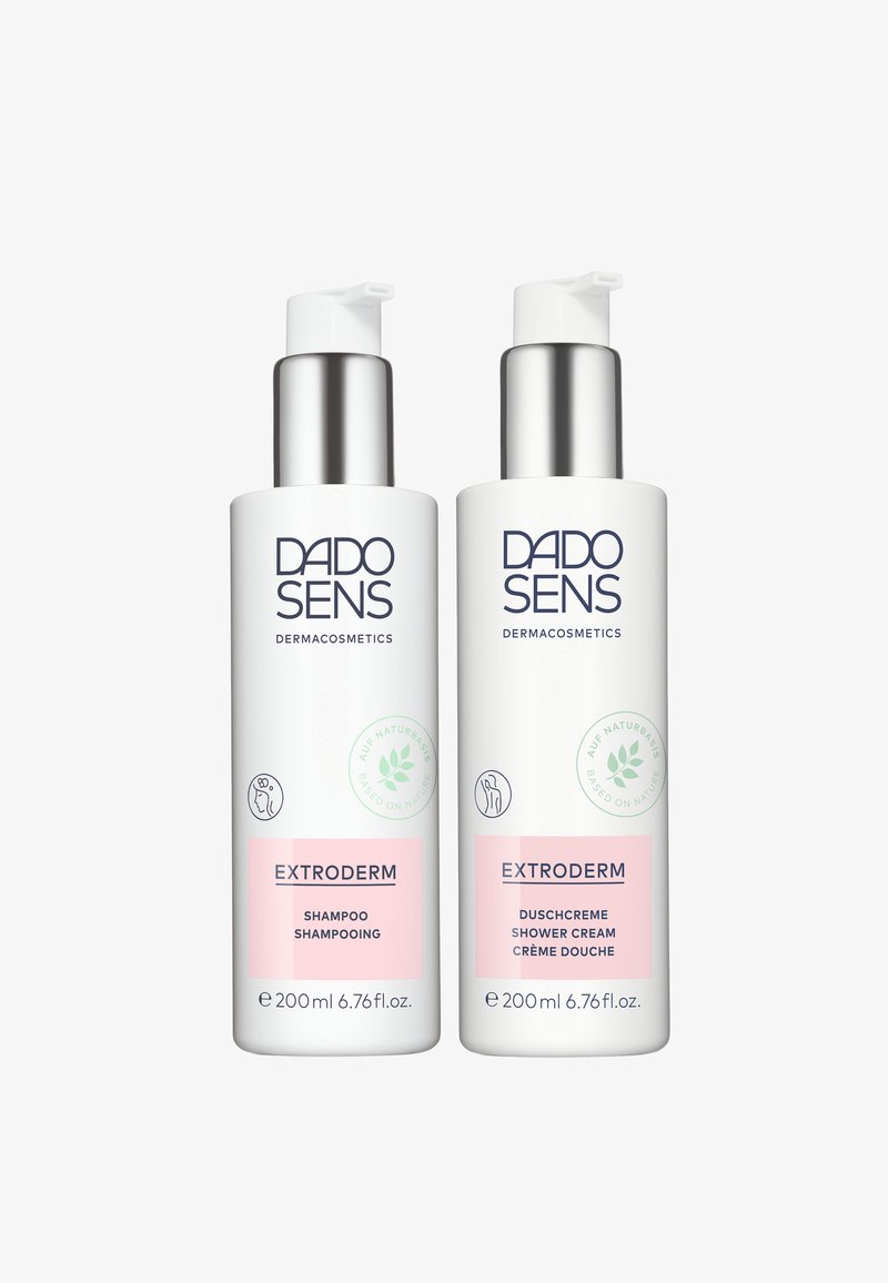 Two white bottles with pump caps, labeled "EXTRODERM" in blue text. One is shampoo, the other is shower cream, both 200 ml. Pink accents.
