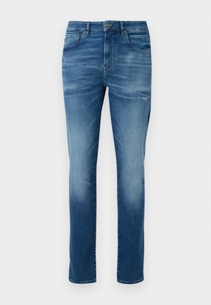 Blue faded slim-fit jeans with button and zipper closure, front and back pockets, and slight distressing on the right thigh.