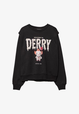 Sweatshirt noir avec le texte "Bienvenue à Derry, Maine, USA" et un clown cartoon tenant un ballon rouge imprimé sur le devant.