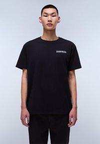 Black cotton T-shirt with a relaxed fit, featuring a crew neck and short sleeves. Small white logo printed on the left chest area.