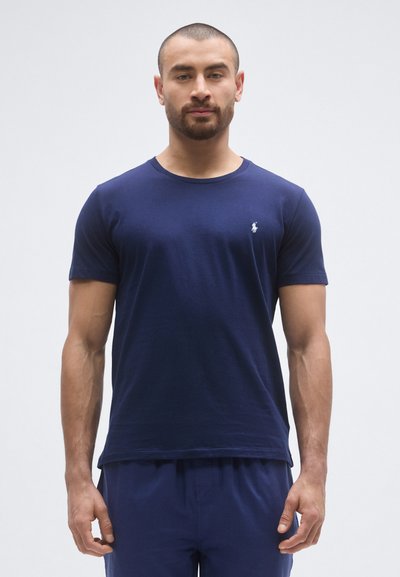 Navy blue cotton crew-neck t-shirt with short sleeves and a small logo on the chest. Soft texture, straight cut, and casual design.