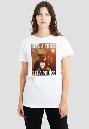 White t-shirt featuring a graphic of a frog in a tuxedo with the text "KISS A FROG, GET A PRINCE." Simple design with a relaxed fit.