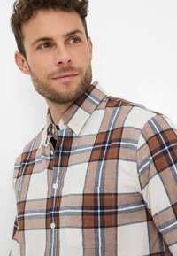 Hemd mit Knopfleiste in Kariert mit braunen, marineblauen und beigen Farben. Hergestellt aus einem Stoff mit glatter Textur. Verfügt über eine Brusttasche.