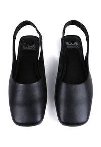 Black leather slingback shoes with a square toe design, smooth texture, and minimalistic style, featuring a low heel and open sides.