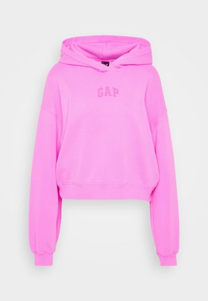 Beskaaret hættebluse i lys pink, lavet af blødt materiale, med lange ærmer, snore i hætten og ordet "GAP" trykt i en lysere nuance.