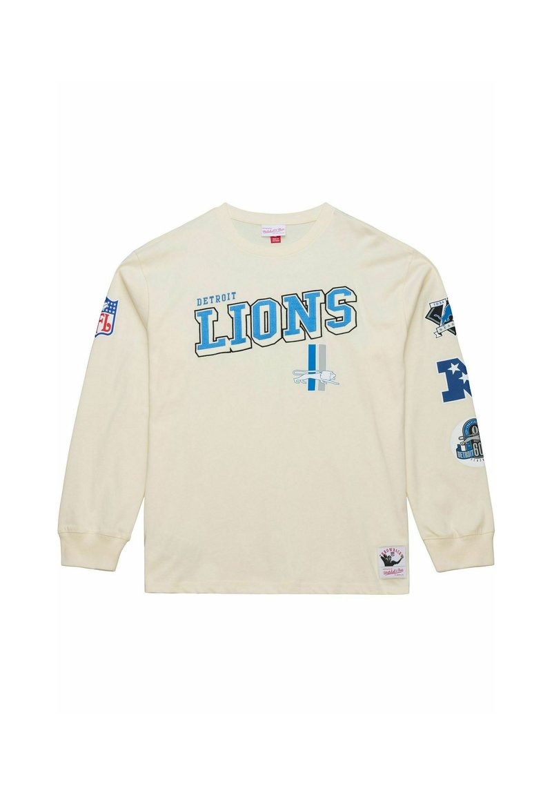 Cream long-sleeve T-shirt with "Detroit Lions" in blue lettering. Features team logos on sleeves and a patch at the bottom. Cotton material.