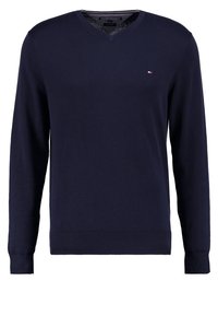 Pull col en V marine en tissu lisse, manches longues, poignets côtelés et petit logo sur la poitrine.