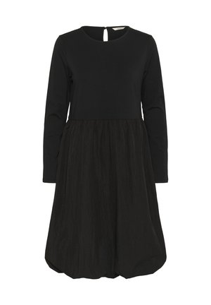 Svart klänning med långa ärmar, rundad halsringning och figurnära bodice. Kjolen är voluminös med en texturerad tyg och en nyckelhål detalj bak.