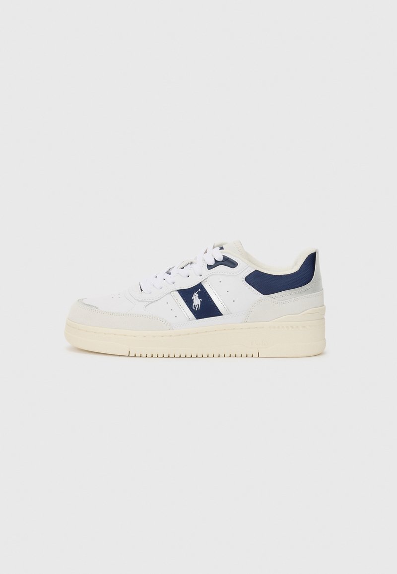 White sneaker with navy accents, leather and textile materials, round toe, lace-up closure, and textured rubber sole. Small logo on side.