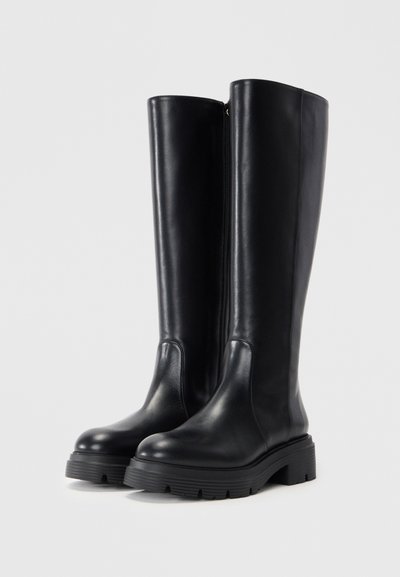 Black leather knee-high boots featuring a rounded toe, chunky rubber sole, and a side zipper. Smooth texture with minimal detailing.