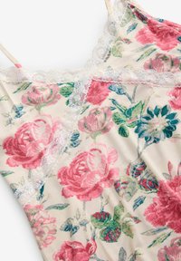 Kreemivärvi lilleline kampsun, millel on erksad roosa ja rohelise roosi muster. Kvaliteetne pitsääris kaeluse ja rihmade ääres lisab peent detaili.