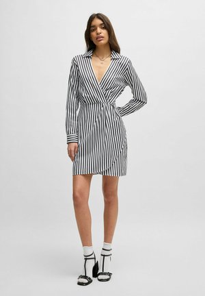 Black and white striped wrap dress with long sleeves, a collared neckline, and a tie at the waist. Features a mid-thigh length.