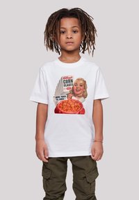 White cotton t-shirt featuring a vintage Kellogg's Corn Flakes graphic, highlighting a bowl of cornflakes and a smiling woman.
