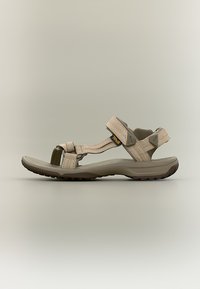 Μπεζ αναπροσαρμόσιμος πεζοπορικός σανδάλια με λουράκια velcro, μαλακή σόλα και υφασμένο ελαστικό πέλμα για κράτημα, με τοποθετημένο πορτοκαλί λογότυπο Teva.