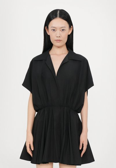 Schwarz kurzes Kleid mit kragenförmigem Ausschnitt, weiten Ärmeln und einem elastischen Taillenbund, das einen fließenden Rock und eine glatte Stofftextur aufweist.