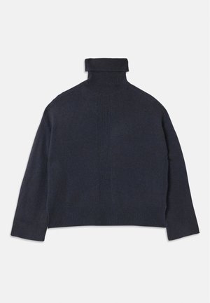 Pull en col roulé bleu marine avec un col en côtes et une texture détaillée. Coupe ample, manches longues et motifs verticaux subtils.