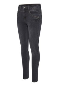 Jean skinny en denim noir avec des coutures jaunes, cinq poches et une fermeture éclair à l'avant. Le tissu a une texture lisse et légèrement décolorée.