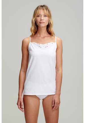 White cotton tank top with thin straps, featuring a lace trim at the neckline. Smooth texture, minimalistic design, and relaxed fit.