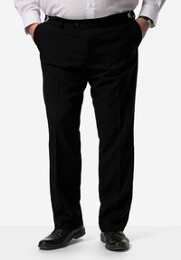Černé kalhoty s úzkým střihem, sklady na přední straně a bočními kapsami. Disponují nastavovacími pásky na opasek a elegantními černými botami.