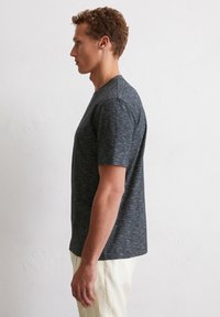 Herren Kurzarm T-Shirt mit Rundhalsausschnitt in Dunkelgrau mit einem dezenten melierten Muster. Verfügt über einen lockeren Schnitt und einen geraden Saum.