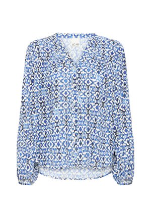 Blouse à manches longues avec boutons sur le devant, poignets élastiques, et motif floral géométrique bleu, blanc et noir.