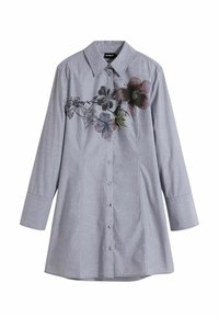 Camicia a maniche lunghe grigio chiaro con colletto a punta, con stampa floreale su un lato e chiusura con bottoni sul davanti. Tessuto liscio e intrecciato.