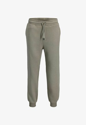 Oliivirohelised dressipüksid, elastse vöökohaga ja nööriga, kitsenevate säärtega, pehme tekstuuriga, küljetaskutega ja soonikkoes mansettidega.