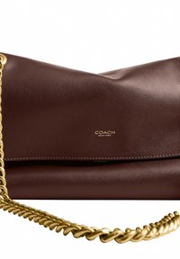 Brown leather Coach New York clutch bag with gold chain strap and smooth texture on a white background.
