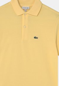 Lacoste Polo - gelb