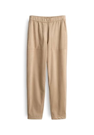 Beige Hosen aus weichem Stoff, mit einem breiten elastischen Bund, zwei Fronttaschen und schmal zulaufenden Beinen. Glatte Textur und minimales Design.