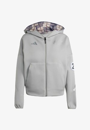 Grauer Reißverschluss-Hoodie mit einem gemusterten lila Karoinnenfutter in der Kapuze, einer Vordertasche und Logodetails auf der Brust und dem Ärmel.