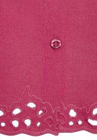 Pink knit top featuring a rounded, scalloped hem with cut-out detailing and a single matching button at the front. Smooth texture throughout.