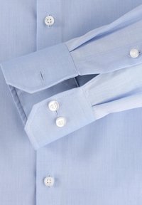 Light blue dress shirt with long, pointed cuffs and two white buttons on each cuff. Smooth texture and subtle vertical stripes throughout.