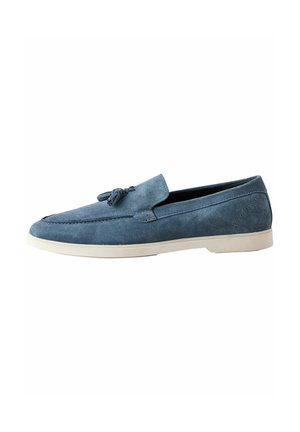Blue suede loafer with tassel detail and white sole, side view on white background.